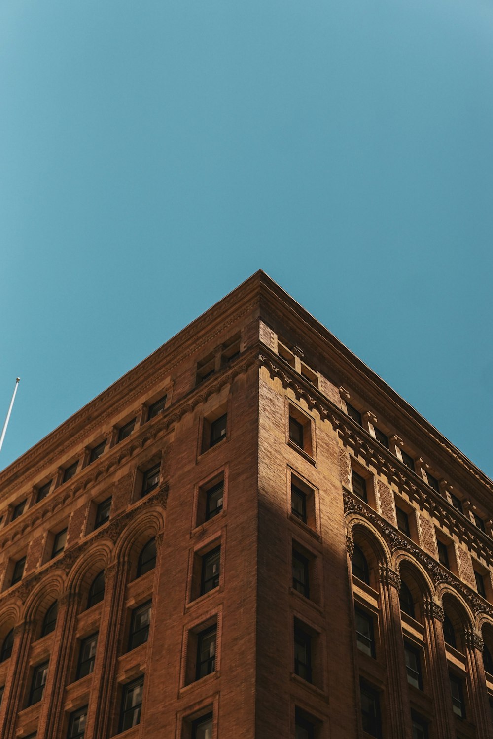 a tall brick building with a blue sky in the background