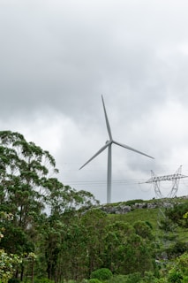A wind turbine towering over the green landscape of Krushna Nagar
