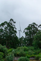 Wind farm in Tallinn with adjacent 4MWh energy storage system under a cloudy northern sky.
