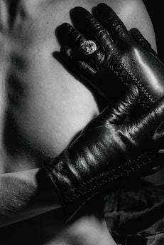 Close-up of textured gloves with futuristic patterns and subtle glowing runes.