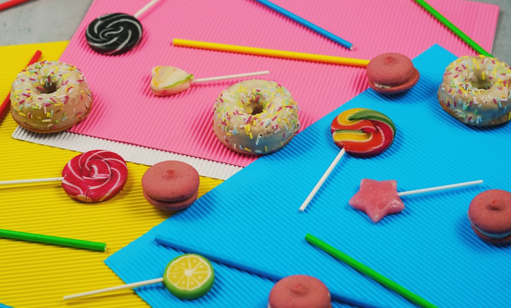 a table topped with lots of donuts and lollipops