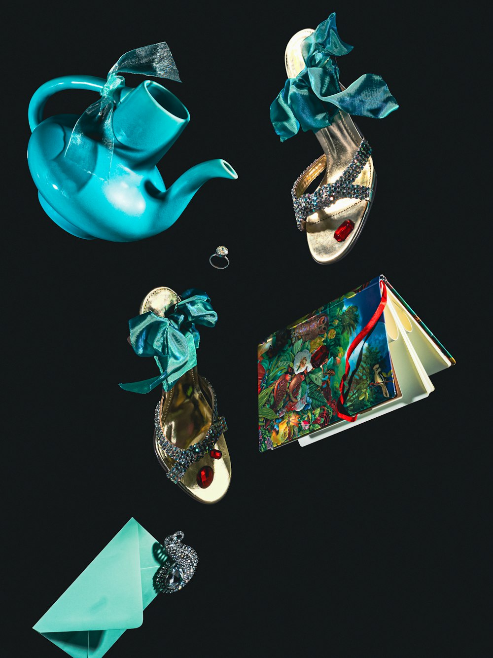 a teapot, a book, and a pair of shoes on a black background