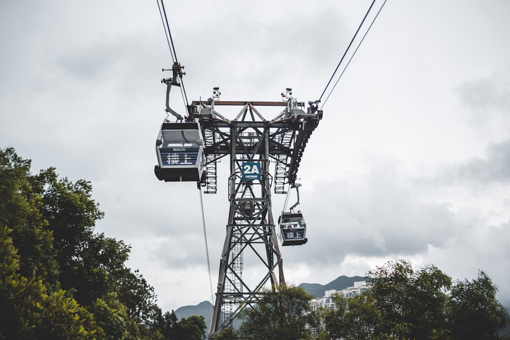 a cable car going up a hill on a cloudy day