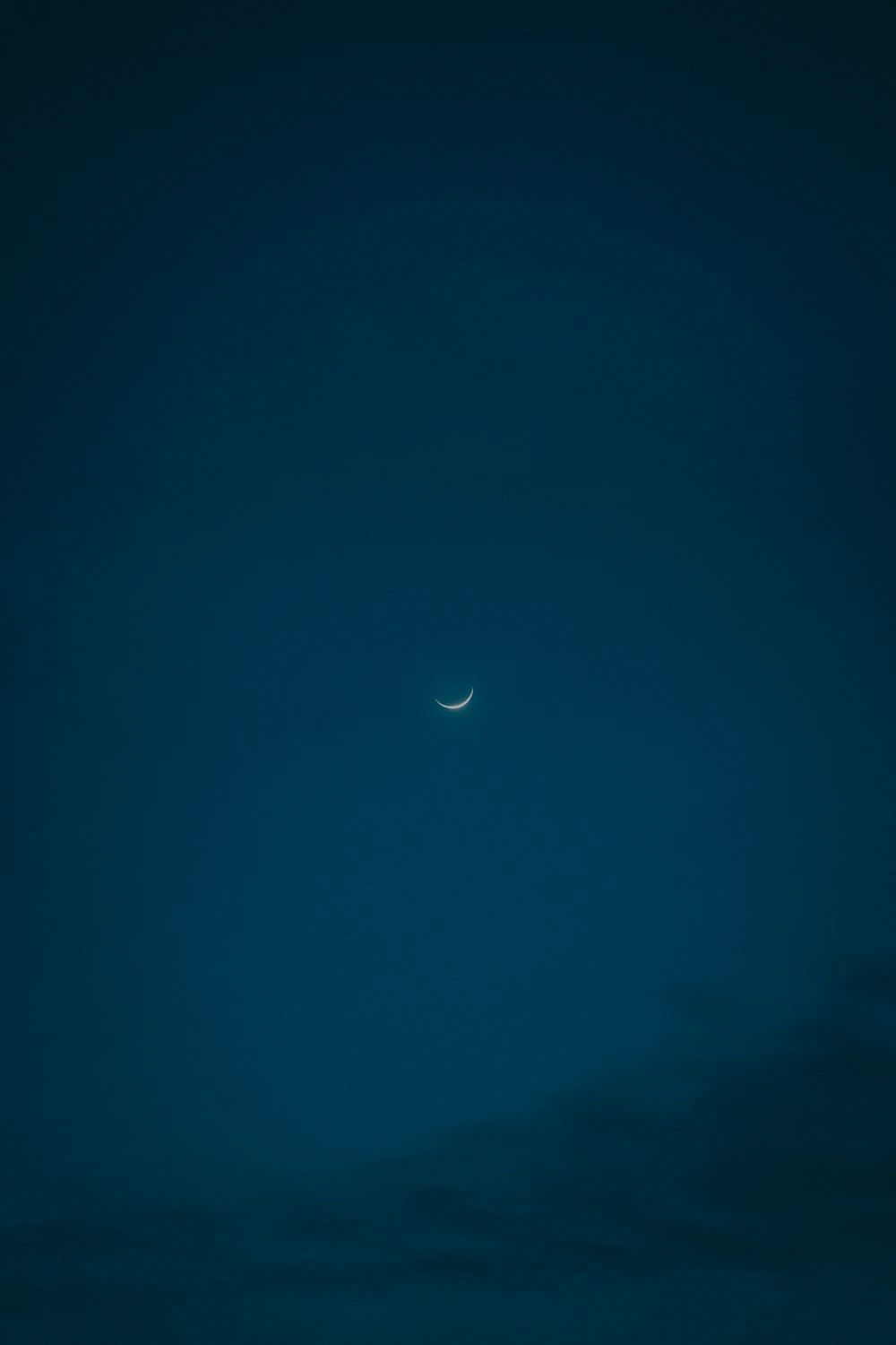 the moon is seen through the clouds in the night sky