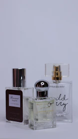 A collage of creators showcasing diverse fragrance brands in natural, everyday settings.