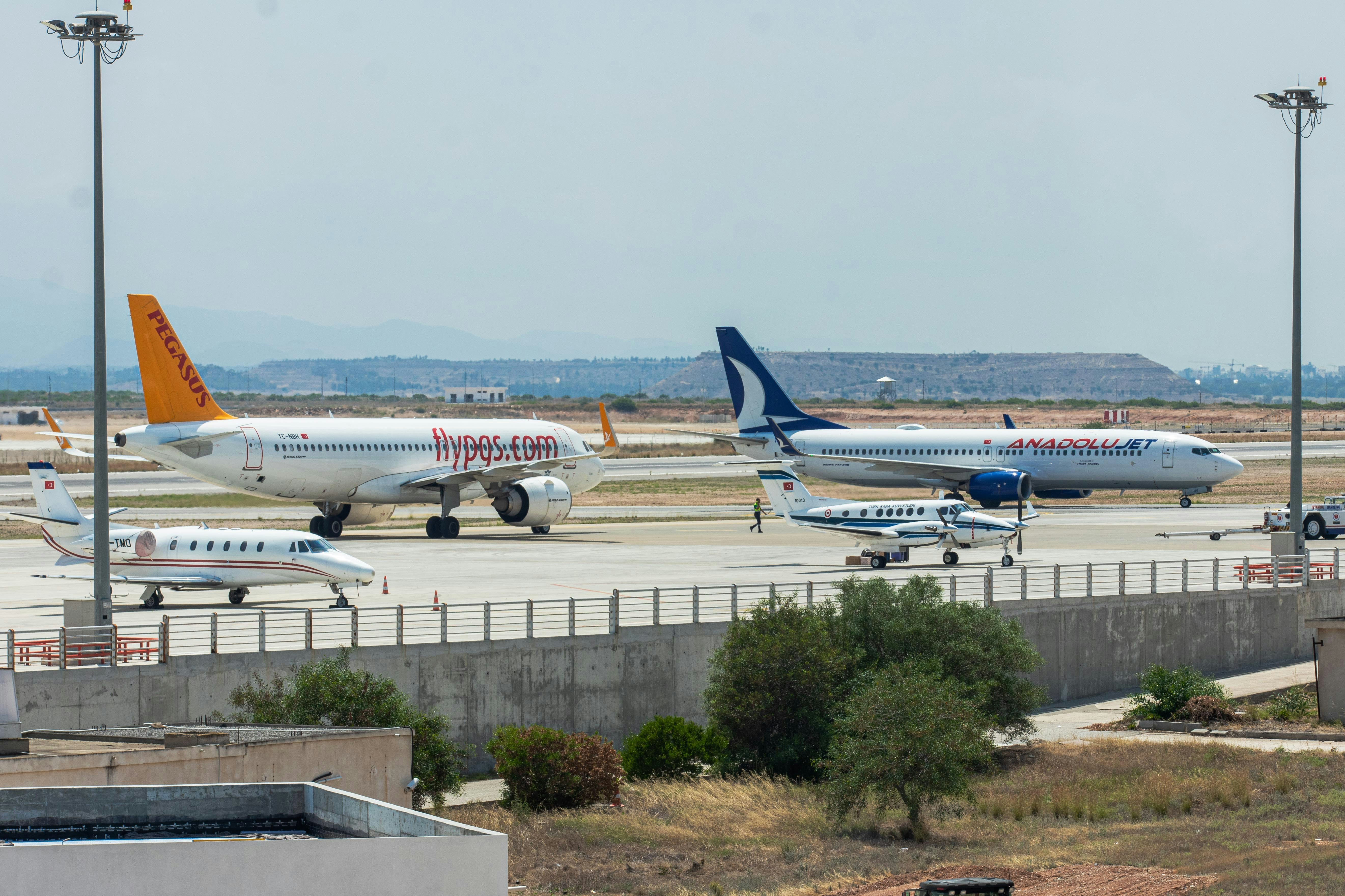 a couple of airplanes that are on a runway, 
