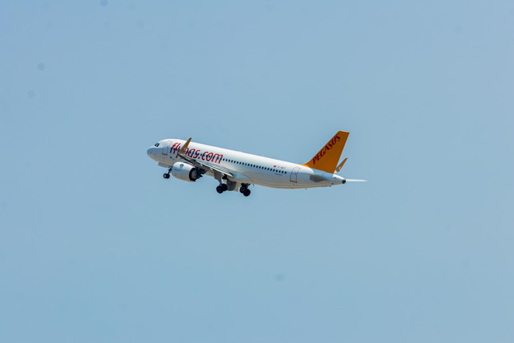 a large jetliner flying through a blue sky