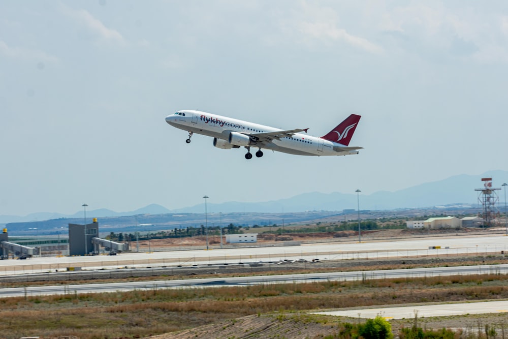 a large jetliner flying through a cloudy sky