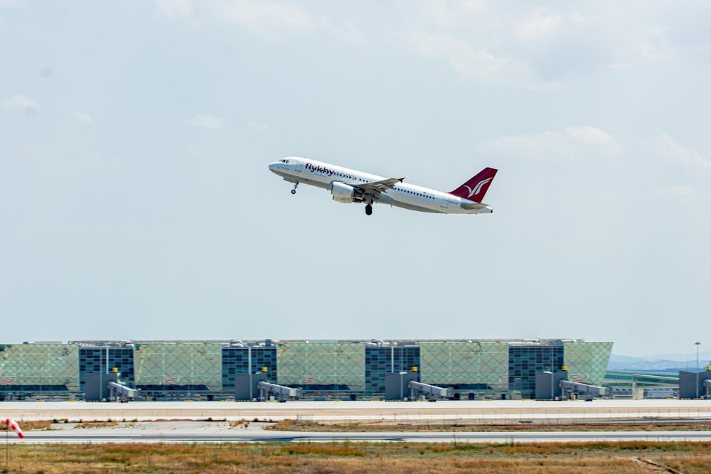 a large jetliner flying through a cloudy blue sky