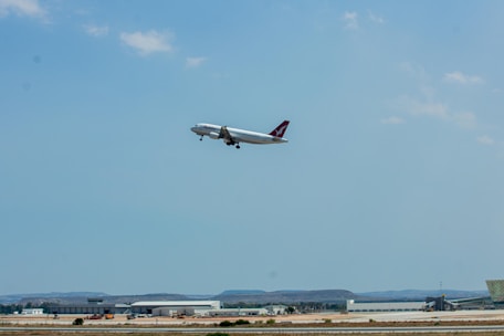 An Ethiopian Airlines airplane taking off against a clear blue sky.