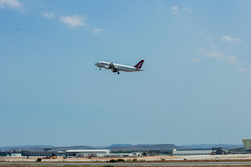 um avião está voando baixo sobre uma pista