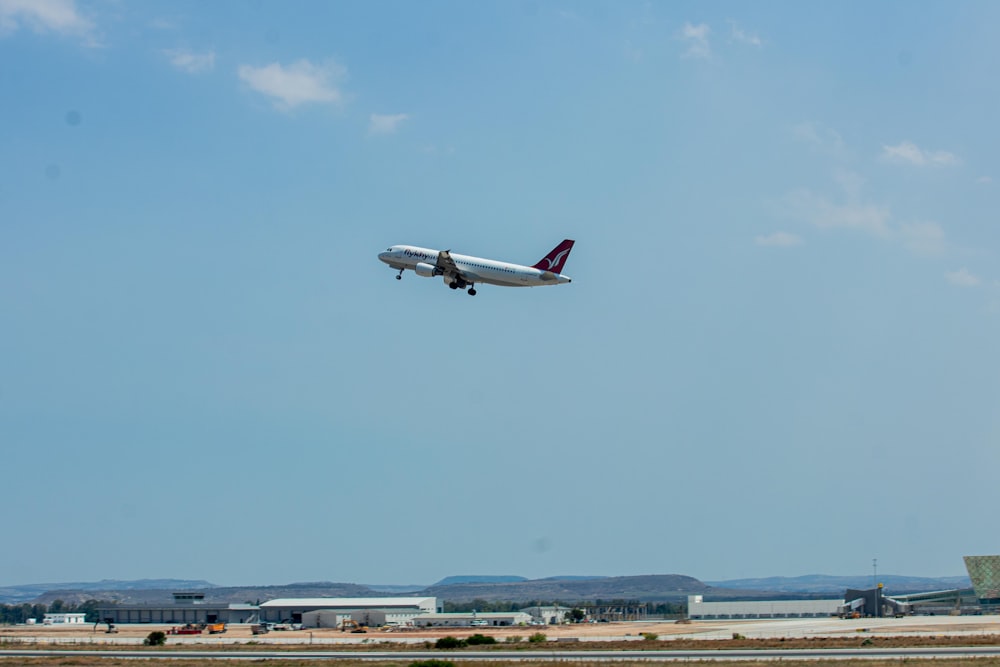 an airplane is flying low over a runway