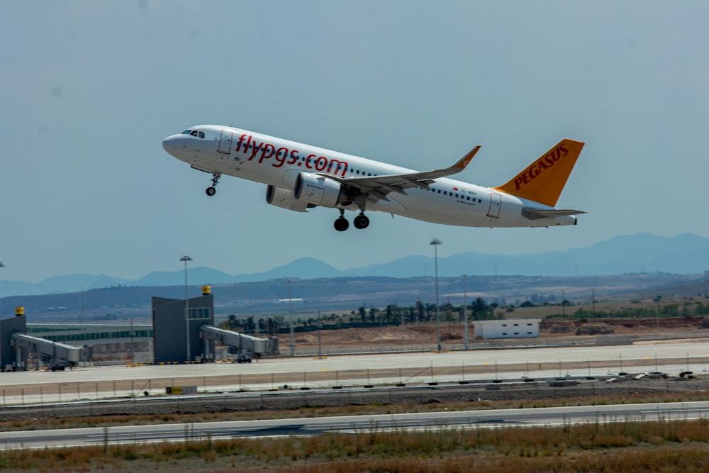 a large passenger jet taking off from an airport runway