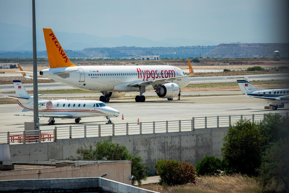 a couple of airplanes that are on a runway