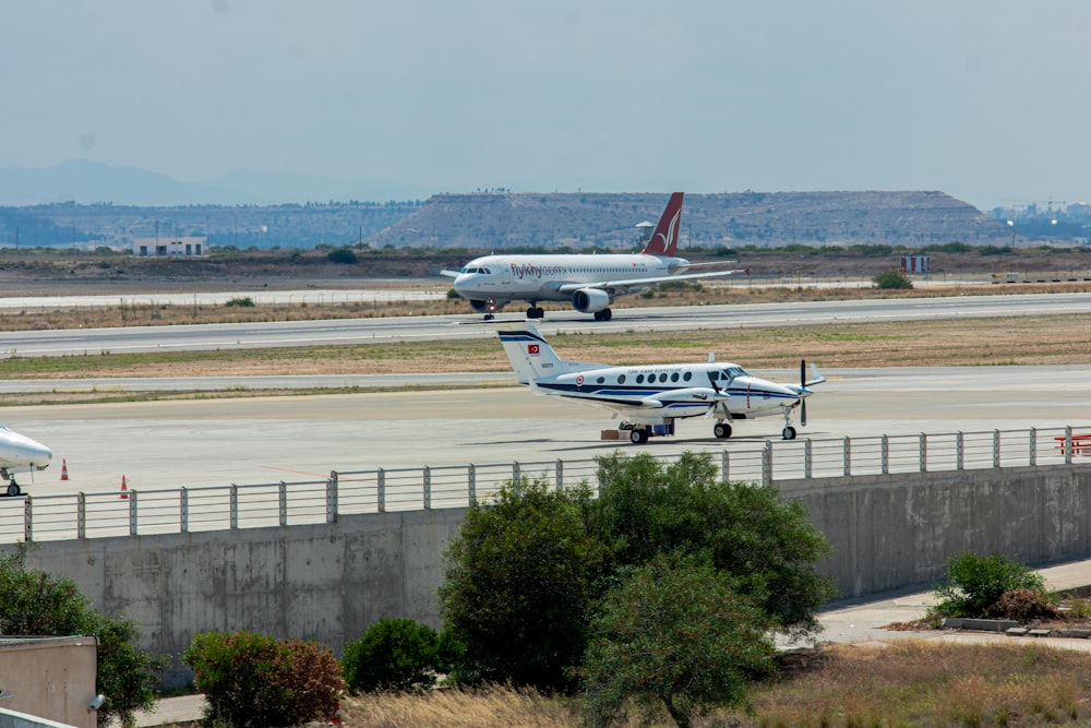 a couple of planes that are on a runway