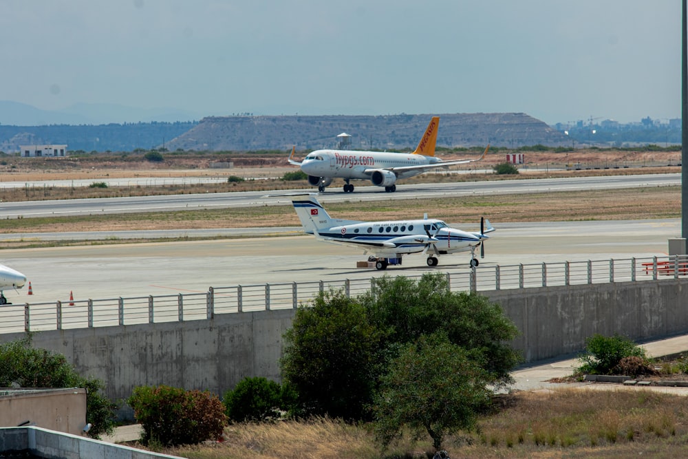 a couple of planes that are on a runway