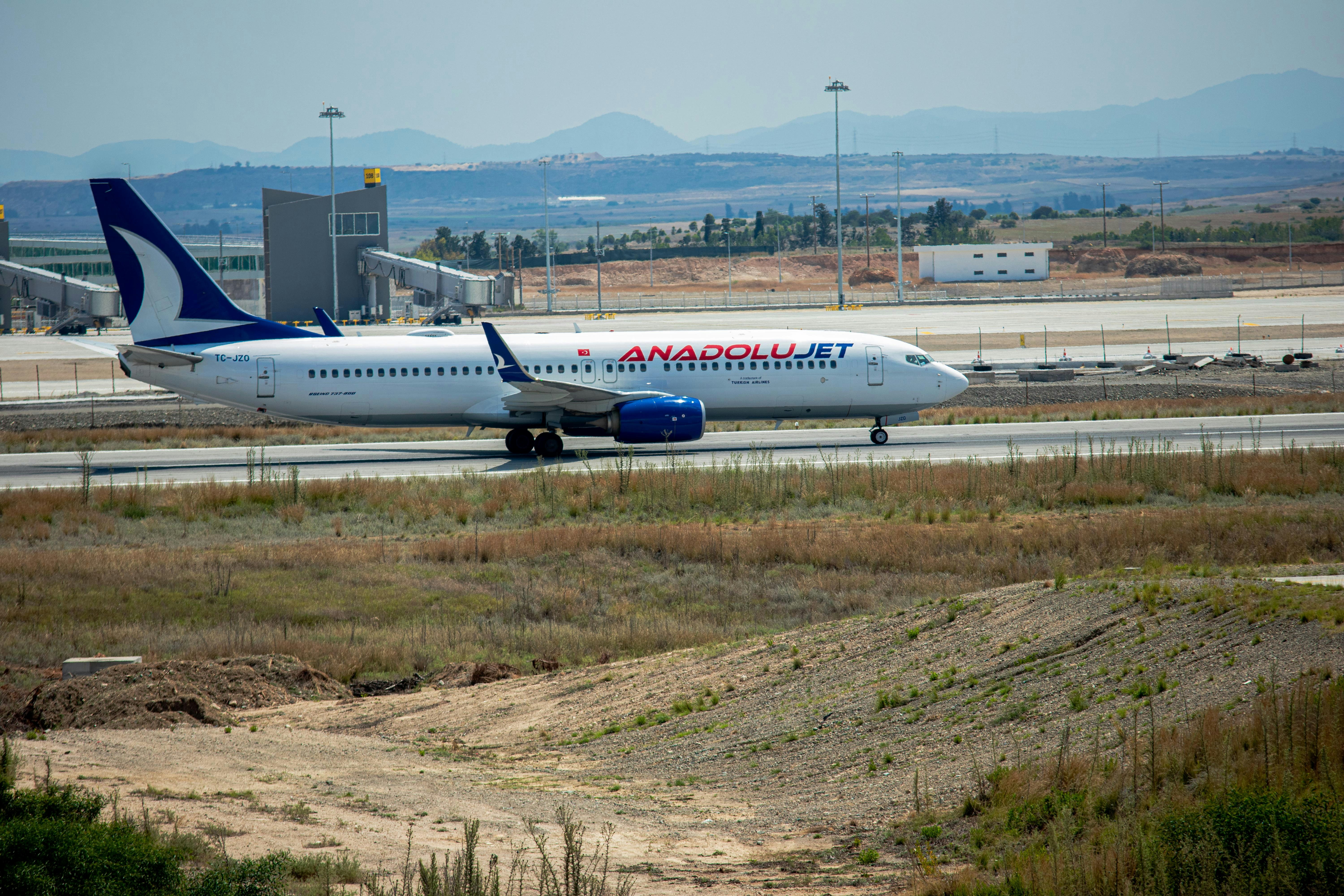 a large jetliner sitting on top of an airport runway, 