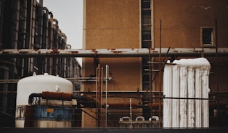 Photo of a technician applying industrial insulation on large piping in a commercial facility.