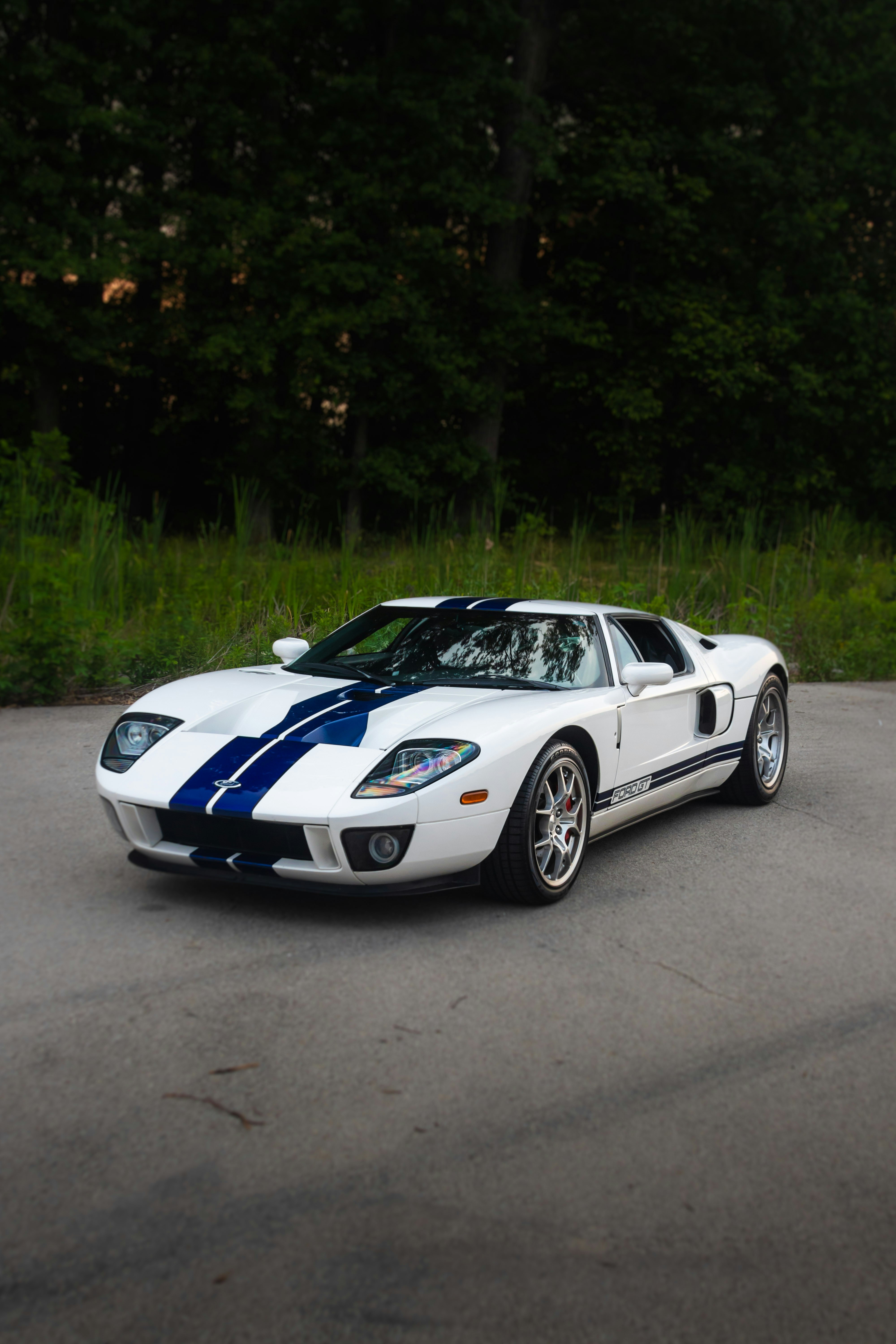 a white and blue sports car parked in a parking lot