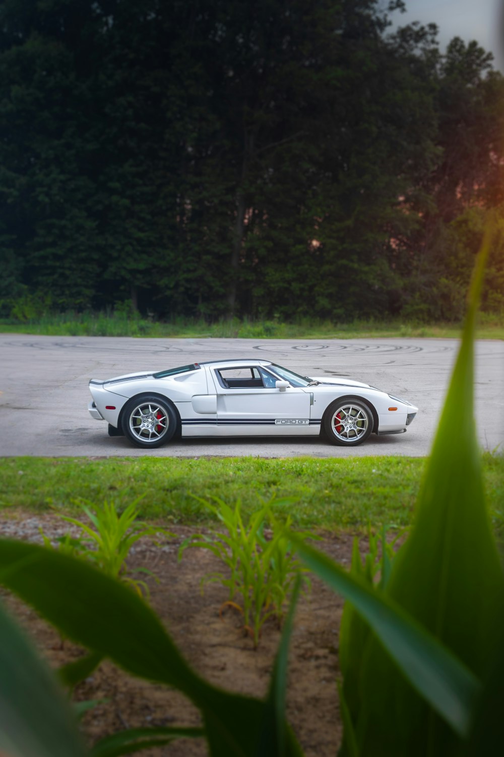 a white sports car parked in a parking lot