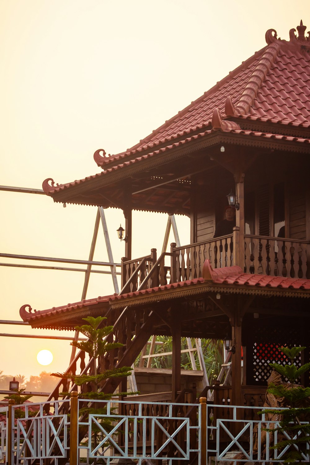a tall wooden building with a red roof