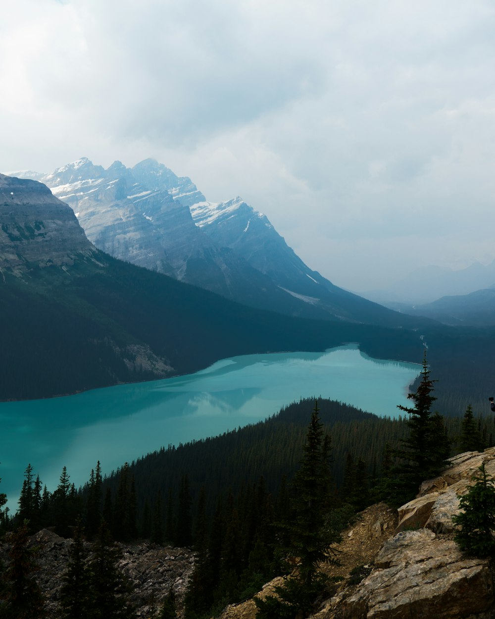 a view of a mountain lake from a cliff