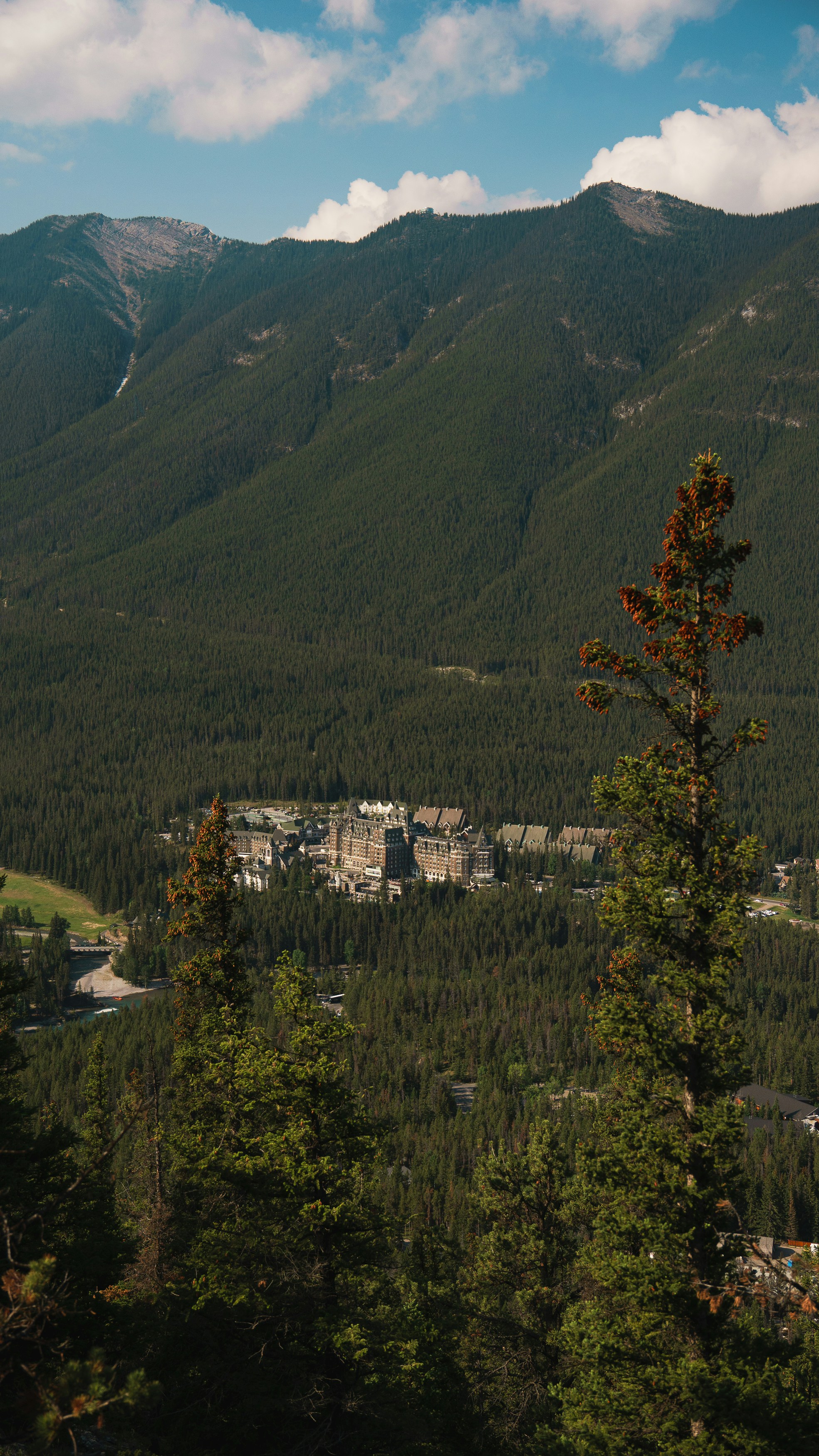 a view of a city nestled in the mountains