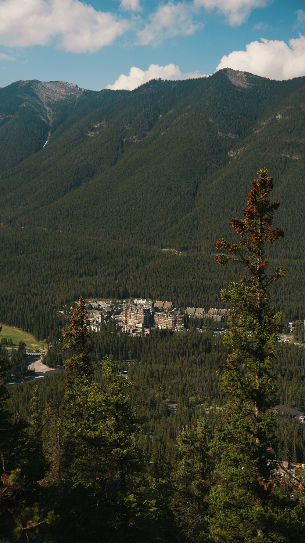 a view of a city nestled in the mountains