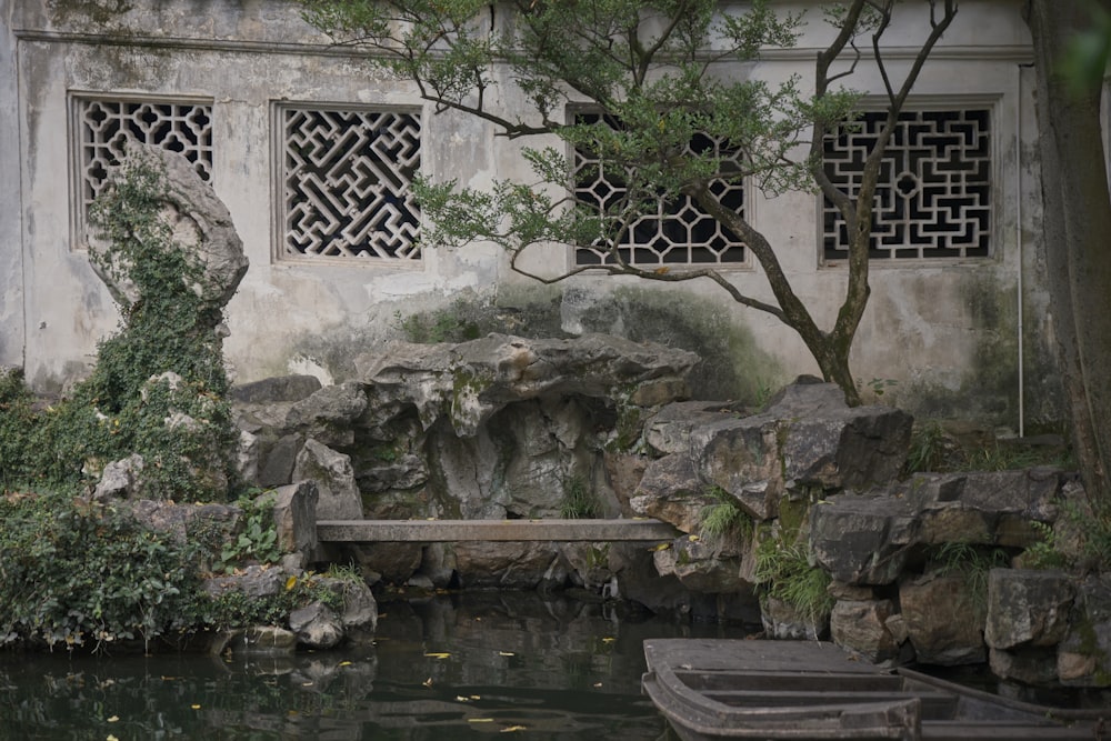 a small pond in front of a stone building