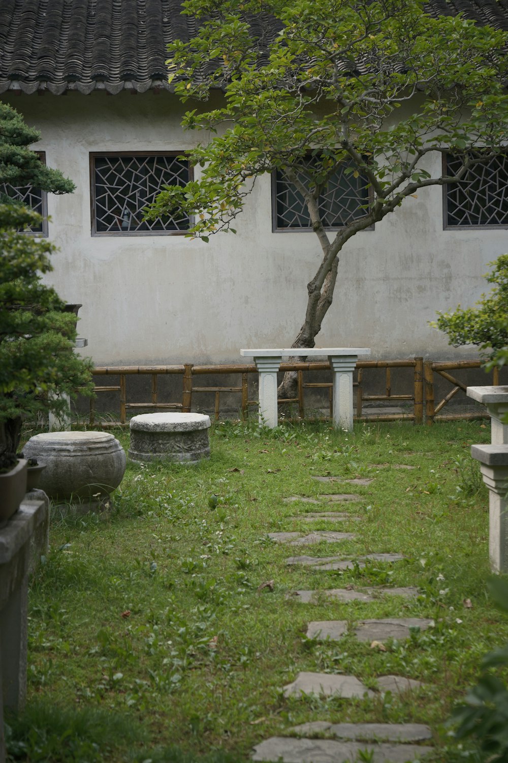 a stone path in front of a white building