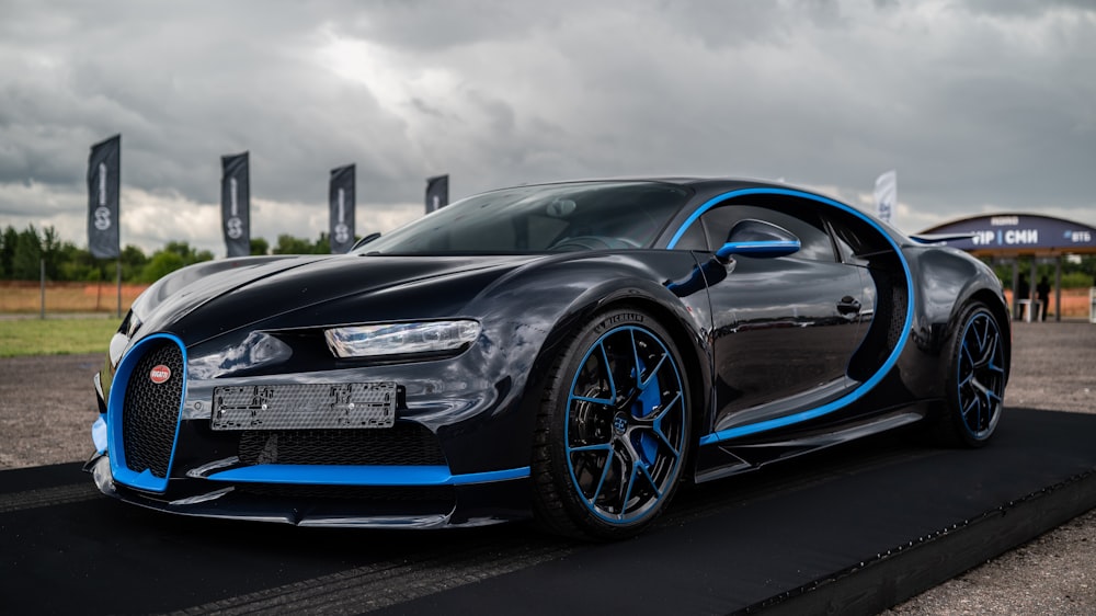 a black and blue bugatti on a parking lot