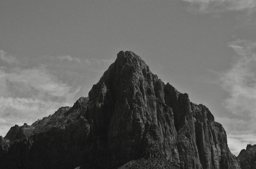 a black and white photo of a mountain peak