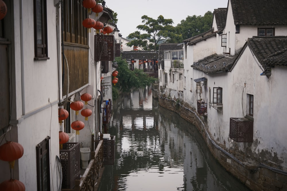 a river running through a small town next to buildings