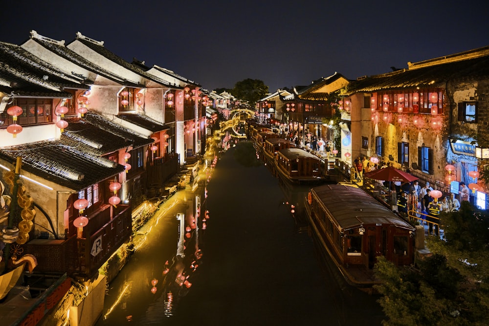 a street lined with lots of buildings and lit up lanterns