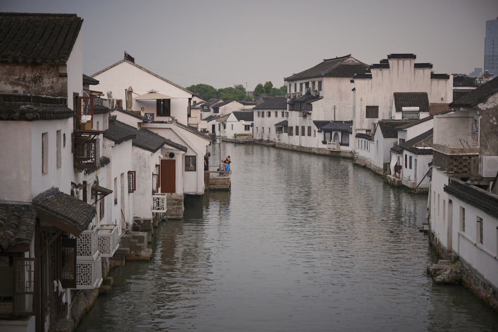 a river running through a city next to tall buildings