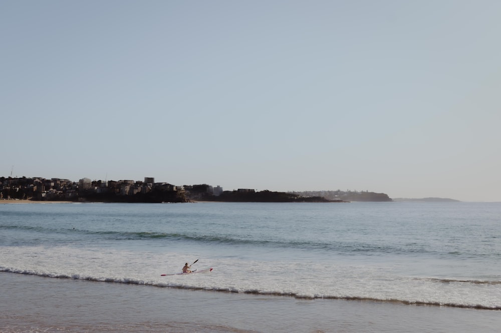 a person riding a surfboard on a wave in the ocean