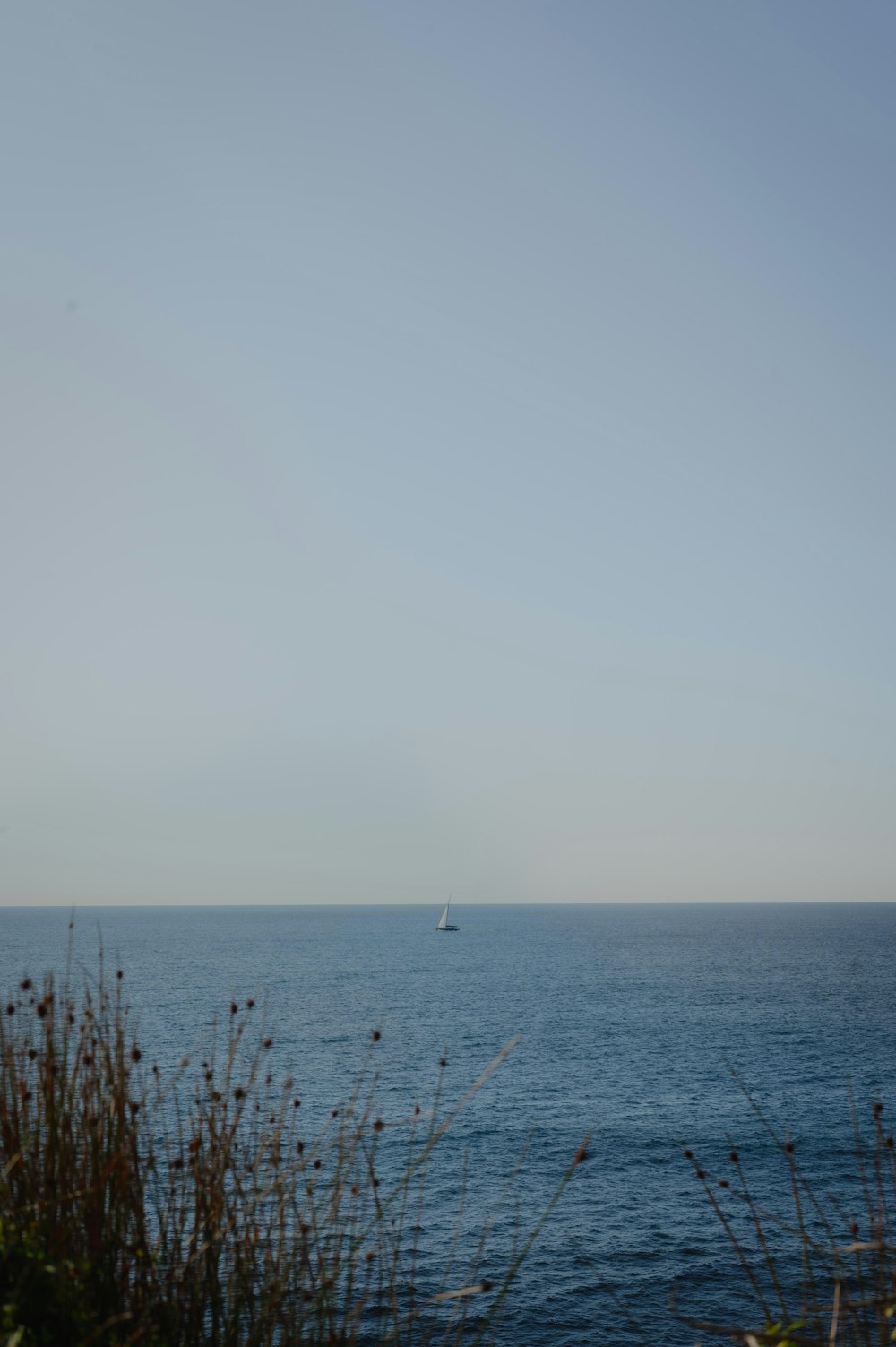 a boat is out in the ocean on a clear day