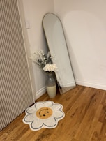 Living room corner with a round mirror installed, highlighting warm tones and cozy textures.