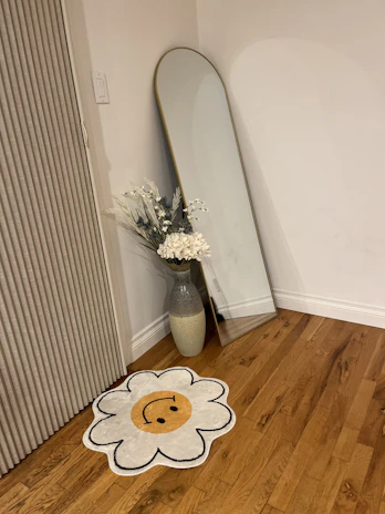 A cozy corner featuring a decorative panel and a stylish mirror from the luxury wall decor collection.
