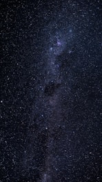 A breathtaking view of a starry night sky with a glowing Milky Way stretching across the horizon.