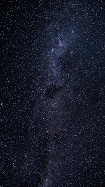 A breathtaking view of a glowing quasar shining brightly against a star-filled night sky.