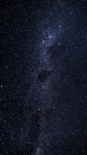 A breathtaking view of a glowing quasar shining brightly against a star-filled night sky.