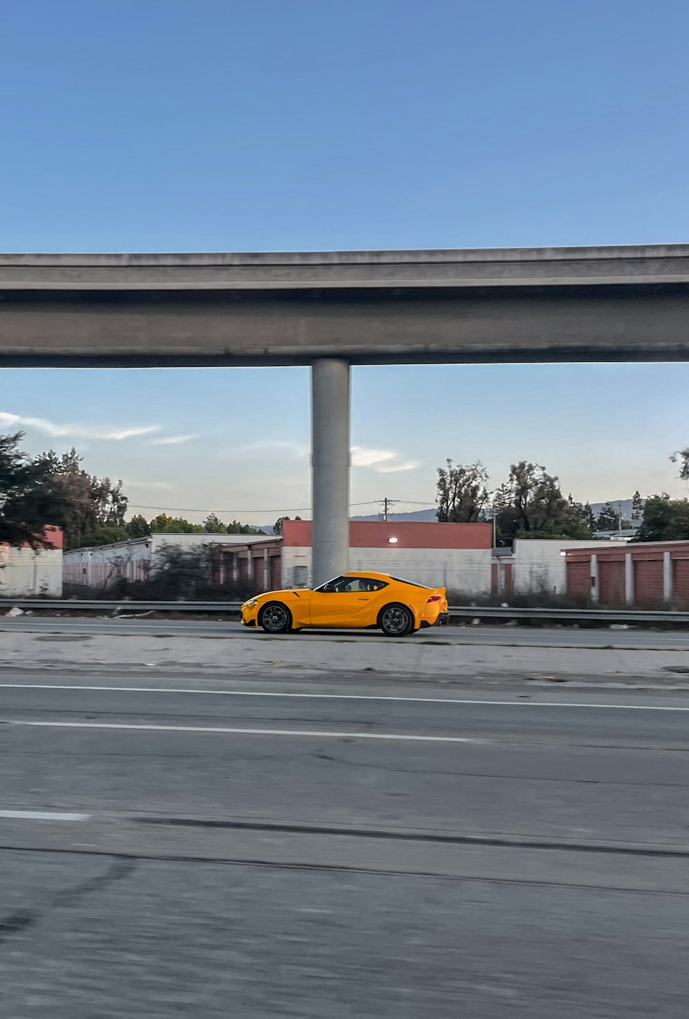 a yellow car is parked on the side of the road