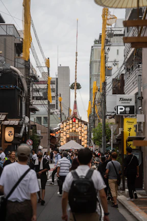 A bustling city street scene during a local festival, with colorful banners and smiling faces.