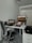 A close-up of a VoIP phone on a modern desk with a laptop.