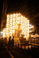 Vibrant lanterns glowing during a lively festival in downtown Kyoto.