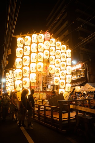 A lively festival scene in Tokyo with lanterns lighting up the night.
