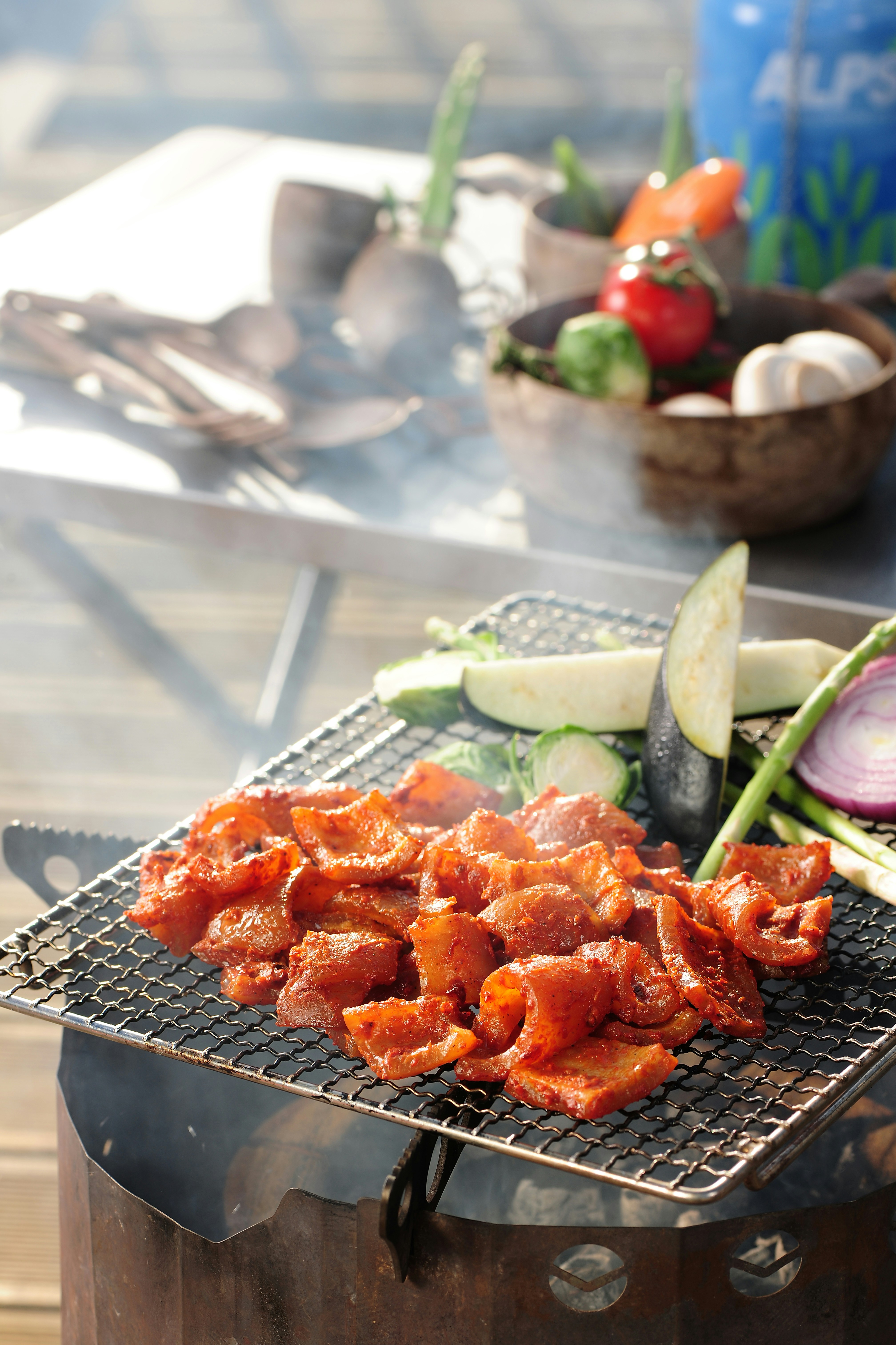 a bbq grill with vegetables and meat on it