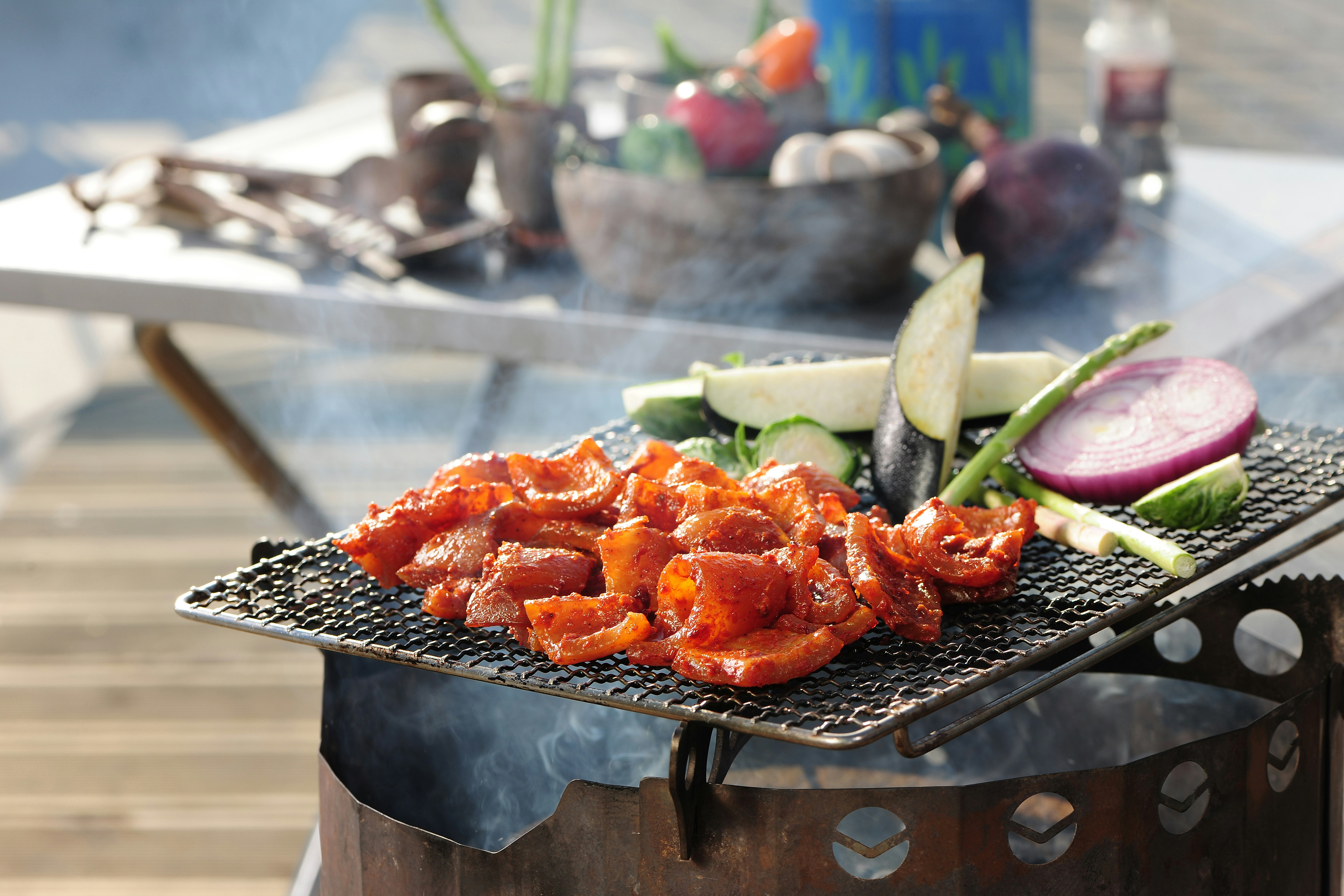 a bbq grill with vegetables and meat on it, 
