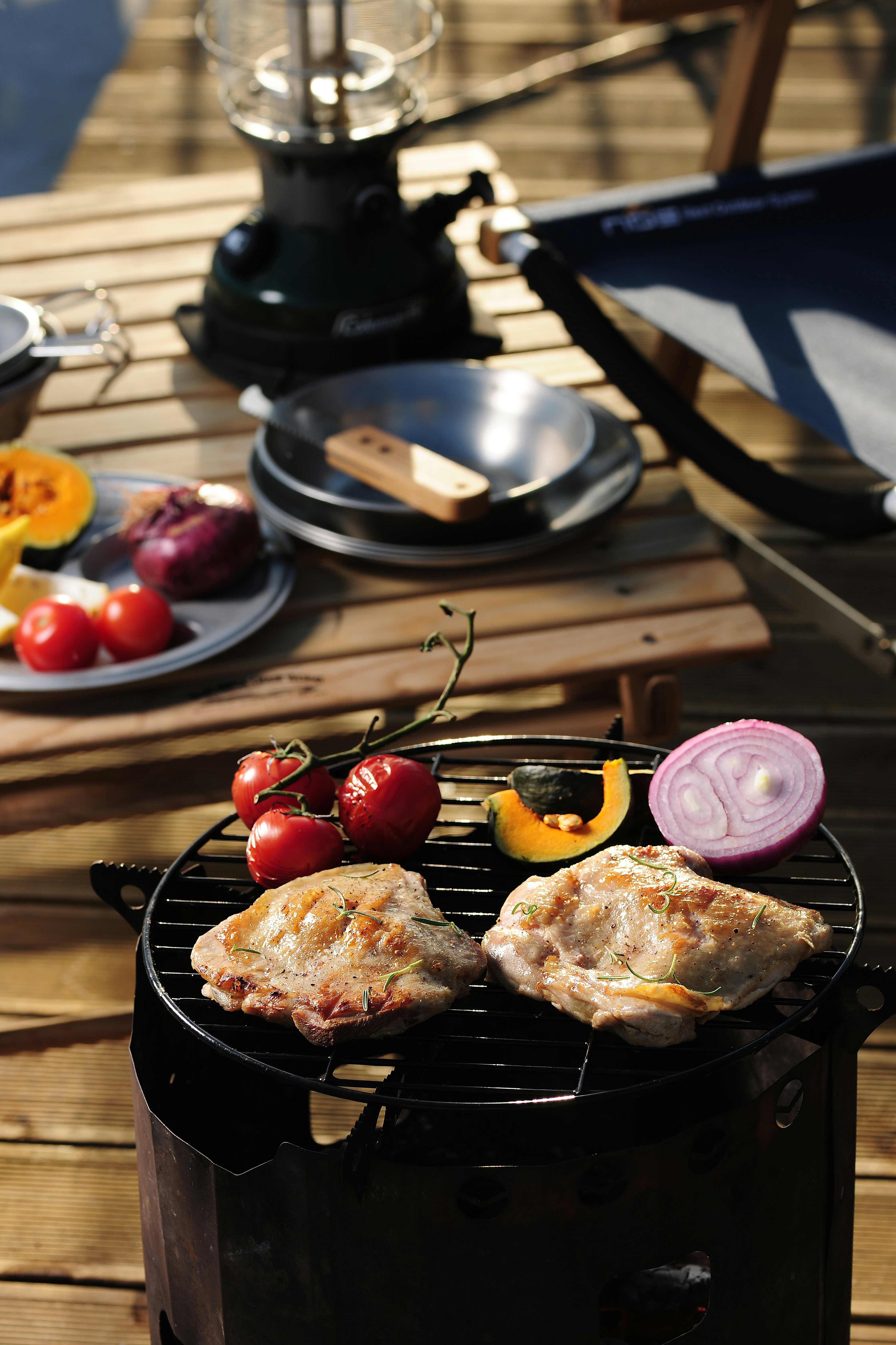 a grill with some meat and vegetables on it